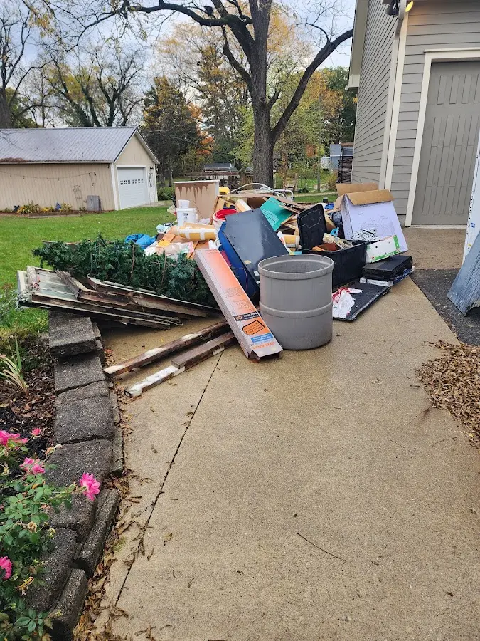 Dumpster being loaded with debris for 30 Yard Dumpster Rental in Eudora